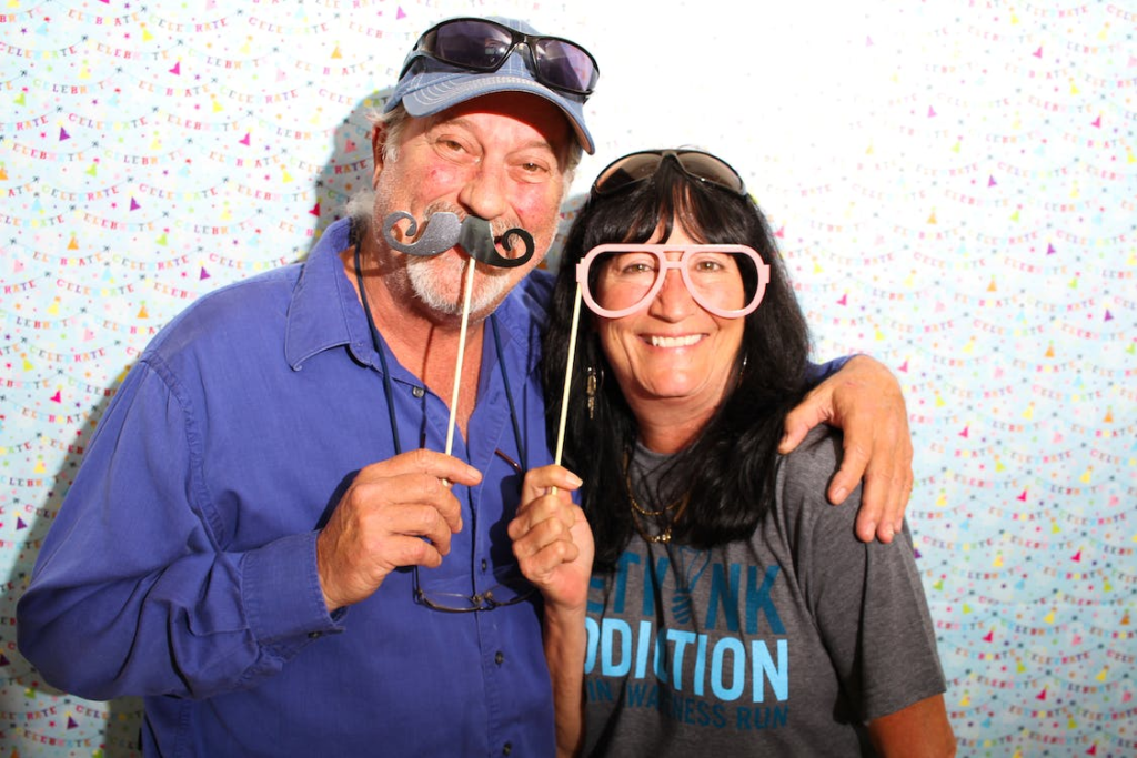 A couple posing for a picture with props