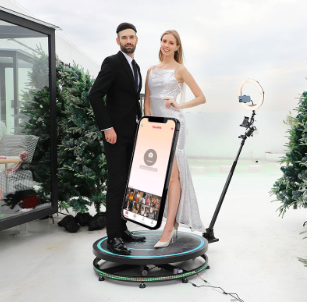 A couple standing on 360 photo booth