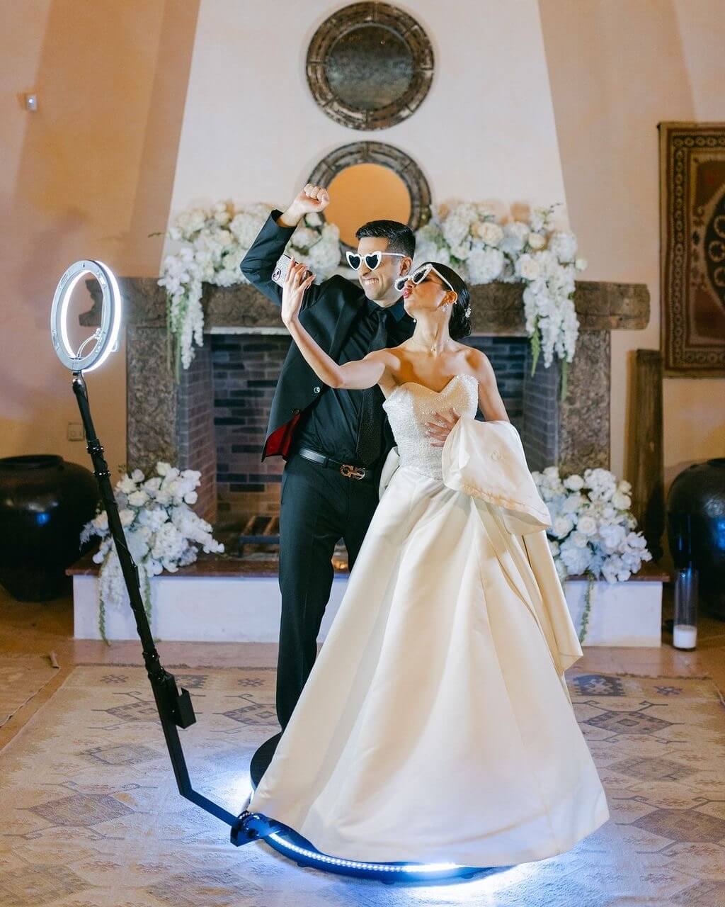 Couple using a 360 degree video booth at a wedding